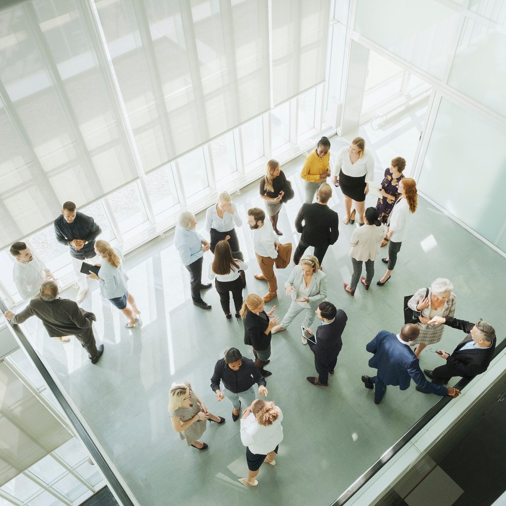 Group of business people in convention setting for workplace giving