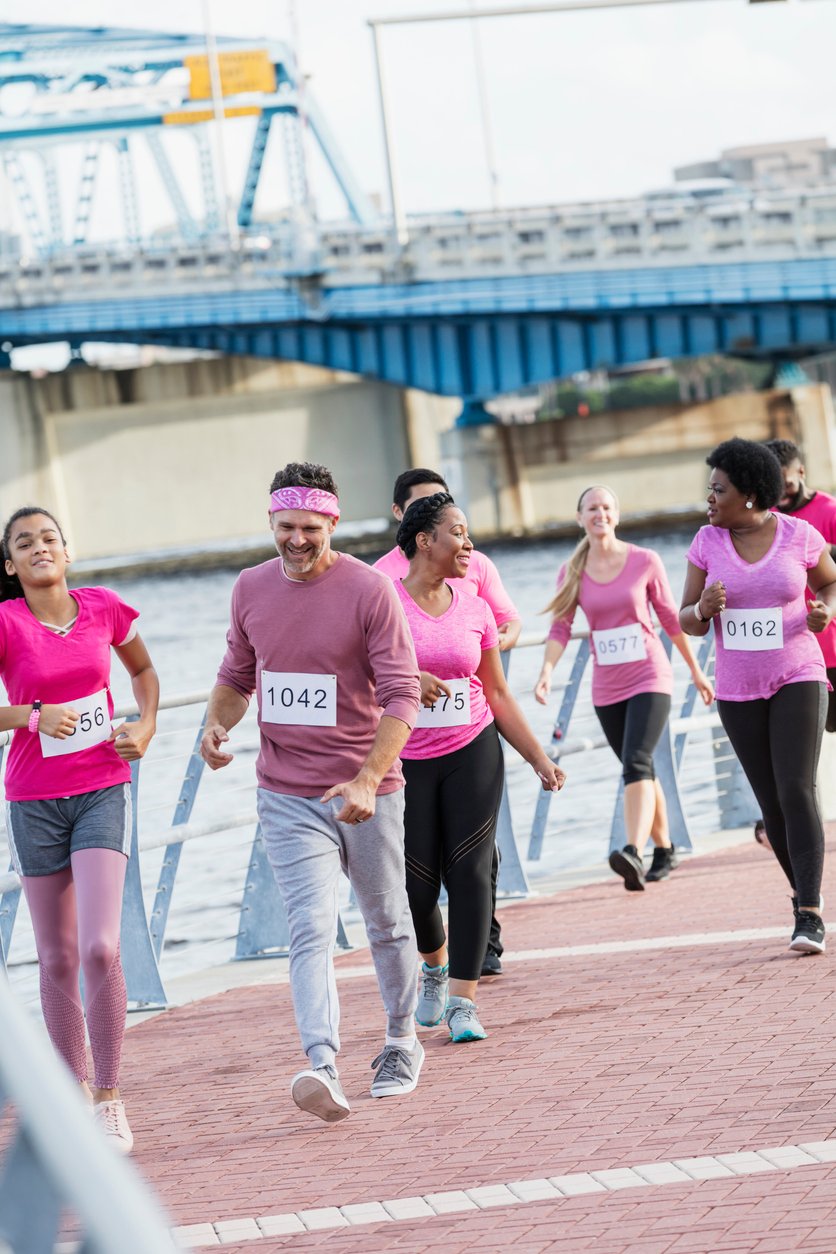 Multi-ethnic group of women, men at charity breast cancer rally