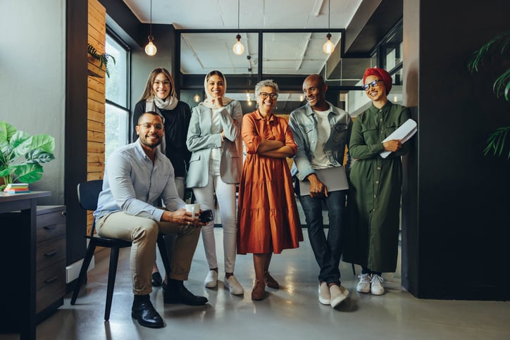 Successful business professionals smiling cheerfully in a modern office group of multicultural businesspeople in an inclusive giving workplace